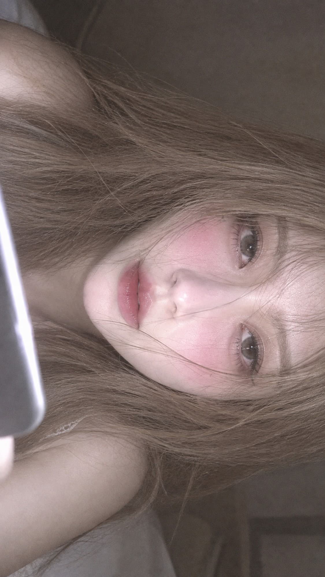 예시 1 - 밝은 휴대폰 화면 빛으로 얼굴이 환하게 뜬 회전 프레임 클로즈업 뷰티 포트레이트